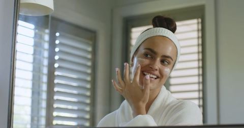 Woman applying facial cream for skincare routine