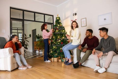 Family Gathering Around Christmas Tree for Holiday Celebration