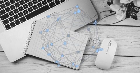 Home office flatlay showing laptop, notebook and digital social network overlay