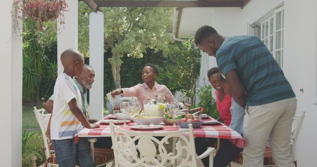 Family Having Outdoor Lunch Gathering at Garden Table - Download Free Stock Images Pikwizard.com