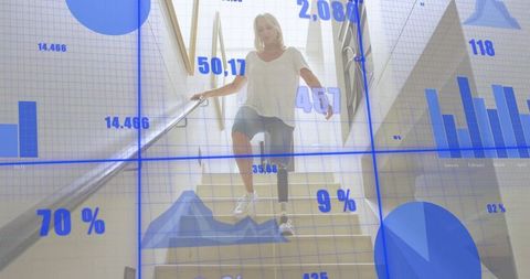 Senior amputee descending stairs with prosthetic leg holding handrail, blue data overlay