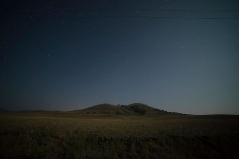 Starry Night Sky Over Serene Rolling Hills