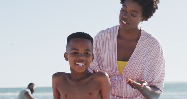 Mother and Child Enjoying Beach Day Under Sunny Sky - Download Free Stock Images Pikwizard.com