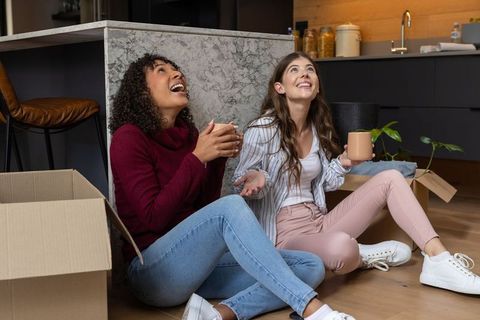 Diverse Friends Cherishing Housewarming Moment with Coffee