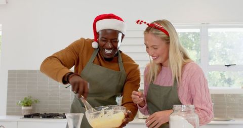 Festive couple enjoying baking activity together in kitchen