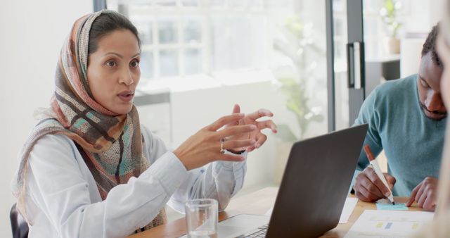 Businesswoman Wearing Hijab Leading Meeting with Team - Download Free Stock Images Pikwizard.com