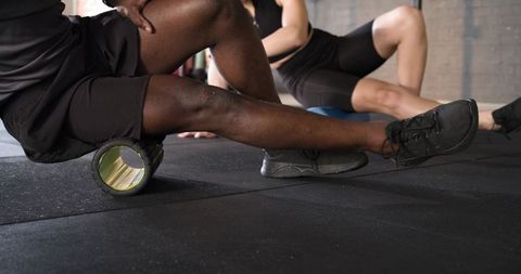 Diverse athletes using foam rollers for muscle recovery