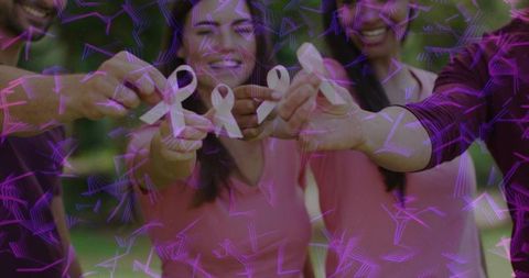 Community holding pink breast cancer ribbons outdoors showing solidarity, support, unity