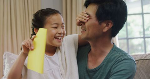 Joyful father and daughter sharing a surprise moment together