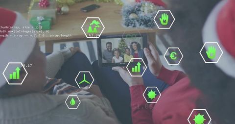 Couple holding tablet watching family video call with festive Santa hats and data overlays