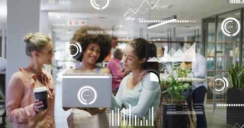 Businesswomen Collaborating in Modern Office with Digital Graphs