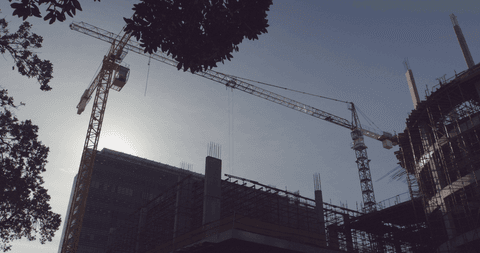 cranes silhouette against clear sky at construction site with transparent contrast - Download Free Stock Videos Pikwizard.com