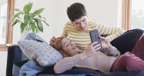 Happy Lesbian Couple Relaxing with Smartphones on Sofa at Home - Download Free Stock Images Pikwizard.com