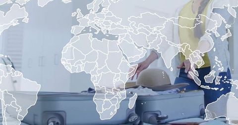 Woman packing suitcase with sun hat and world map overlay for travel planning