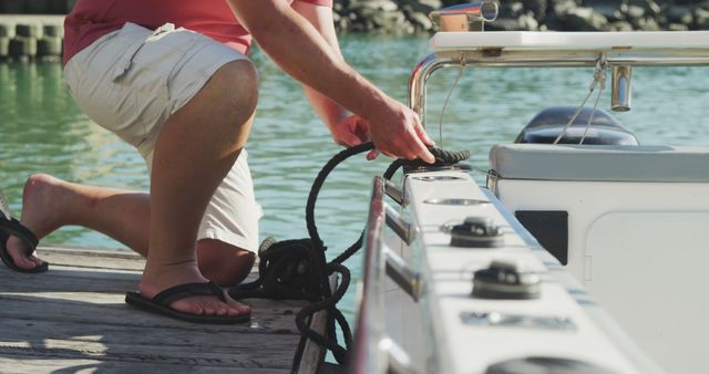 Man mooring boat to dock on a sunny day - Download Free Stock Images Pikwizard.com