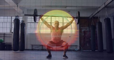 Strong lifter holding barbell overhead in modern gym with digital background