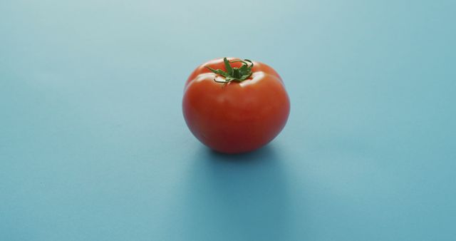Image of fresh tomato with copy space over blue background - Download Free Stock Photos Pikwizard.com