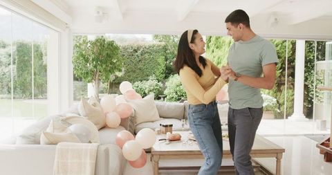 Joyful Couple Dancing in Decorated Living Room Celebration