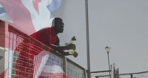 Athlete Ponders Victory Over Sports Court Fence