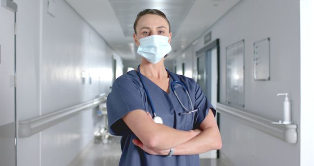 Confident Nurse Standing in Hospital Corridor Wearing Face Mask - Download Free Stock Images Pikwizard.com