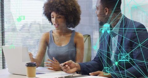 Professionals collaborating over laptop with teal network overlay for teamwork