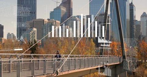 Cyclist crossing modern cabled footbridge with digital data overlays