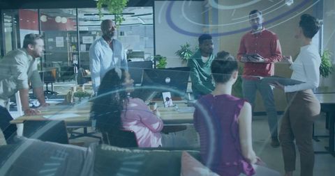 Diverse Team Engaged in Technology-Driven Business Meeting in Modern Office