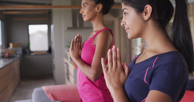 Image of happy diverse women practicing yoga at home. Friendship, spending quality time together at home.