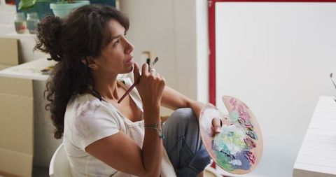 Pensive Artist in Bright Studio Holding Paint Palette - Download Free Stock Images Pikwizard.com