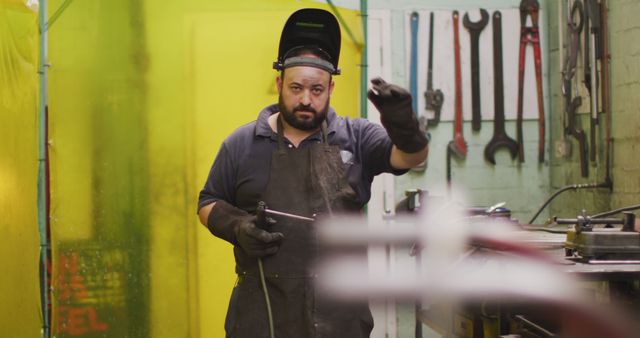 Industrial Worker with Welding Helmet Operating Factory Equipment - Download Free Stock Images Pikwizard.com