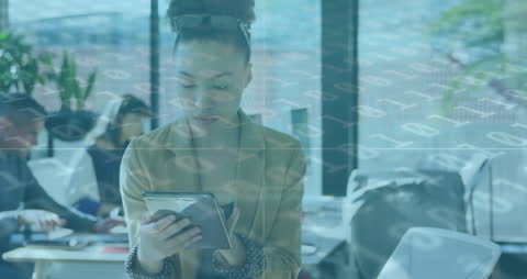 African American Woman Analyzing Data on Tablet in Office Setting