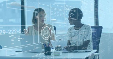 Professional women collaborating on data analytics with transparent HUD in modern office daylight