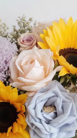 Autofocusing Vertical Video Revealing Sunflower and Pastel Rose Bouquet with Shallow Focus