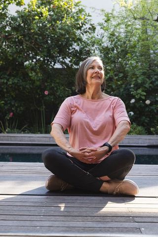 Senior Woman Relaxing Outdoors with Smartwatch