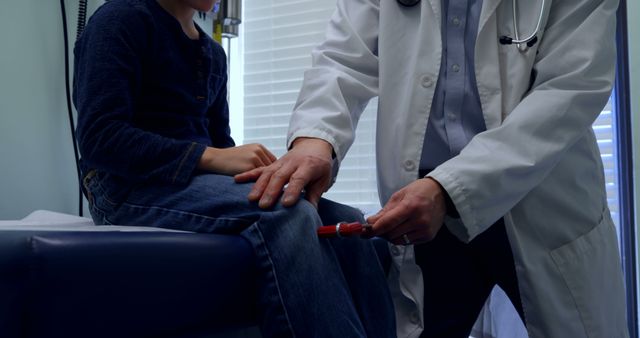 Front view of young asian male doctor examining caucasian boy patient knee in a clinic - Download Free Stock Photos Pikwizard.com