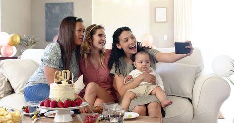 Friends Celebrating with Infant at Birthday Party