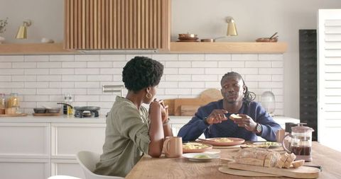 Couple Enjoying Breakfast Dialogue in Modern Kitchen