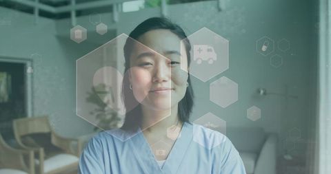 Smiling asian female doctor with healthcare icons overlay