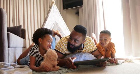Father Bonding with Children Using Tablet in Cozy Living Room
