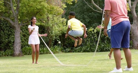Family Enjoying a Summer Day with Jump Rope Outdoors