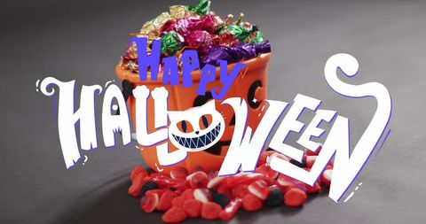 Happy Halloween Text with Pumpkin Bucket and Colorful Sweets