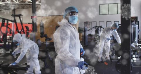 Sanitization Team in Full Protective Gear Disinfecting Fitness Center