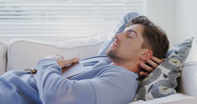 Young Man Napping on Couch Holding Notebook - Download Free Stock Images Pikwizard.com