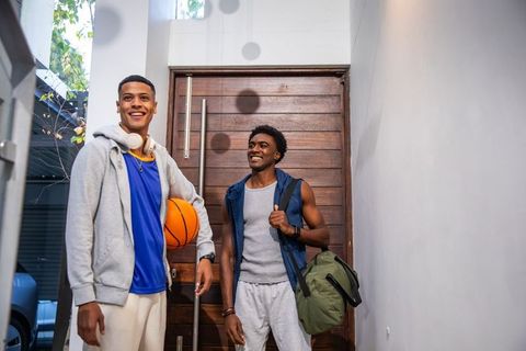 Athletic Friends Returning Home with Basketball and Gear