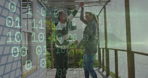 Couple dancing on rustic deck with binary code layer