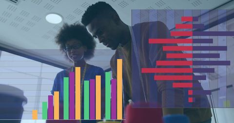 Diverse Professionals Analyzing Financial Graphs in Modern Office