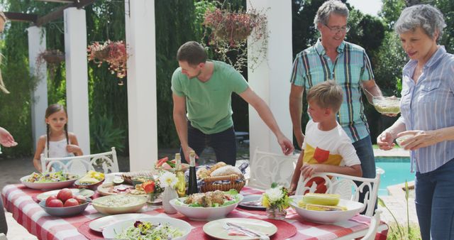 Happy caucasian family setting the table together in garden - Download Free Stock Photos Pikwizard.com