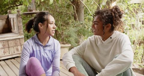 Diverse Friends Chatting Outdoors on Wooden Deck