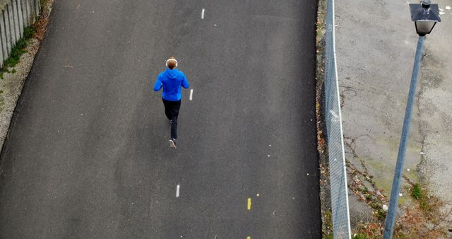 Aerial View of Person Jogging on Empty Road - Download Free Stock Images Pikwizard.com