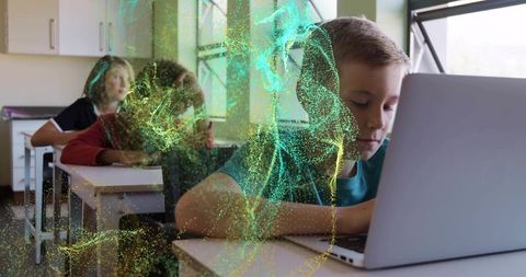 Boy typing on laptop in classroom with green gold particle swirl, digital learning concept